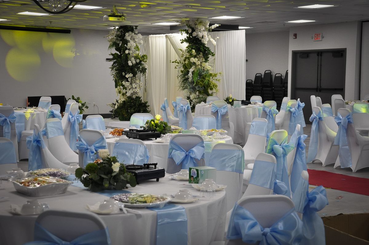 Round dining tables arranged around a floral ceremony backdrop