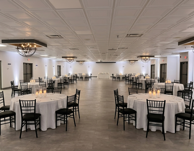Dramatic red and black reception setup with candlelight